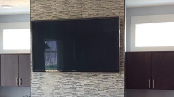 Tv Mounted on wall with power and audio cord in the wall